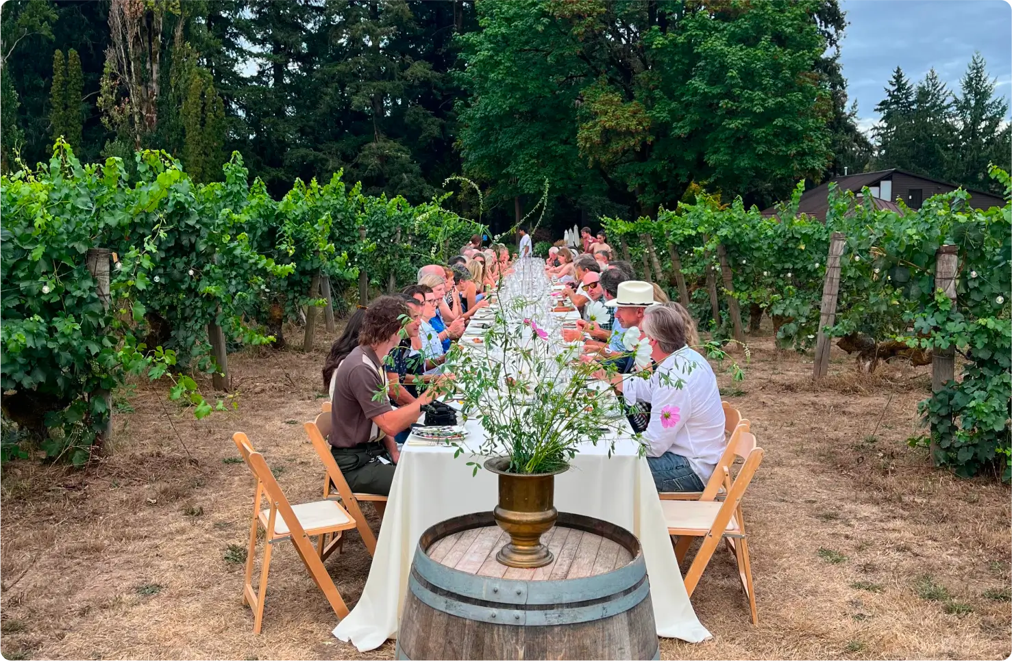 Group of people sitting at a large table outside