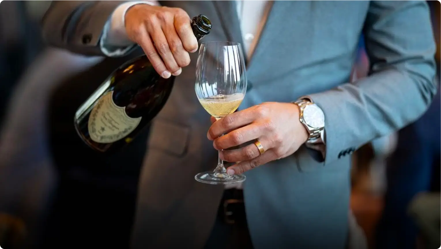 A man pouring wine into a glass